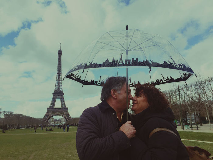 Our love through paris. travel in retirement. enjo or old age winter. umbrellas with paris motifs.  