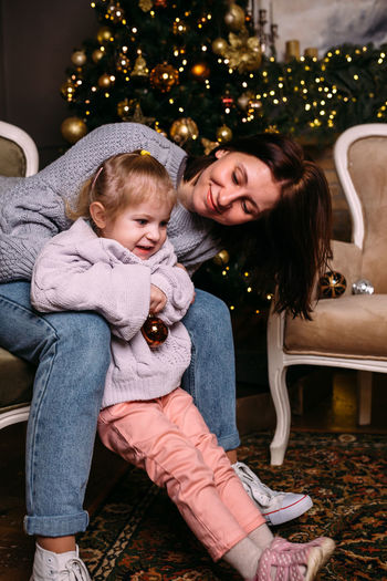 Mother and daughter having fun and relaxing at home. xmas and new year concept