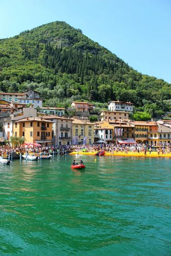 Green mountain and houses by lake iseo
