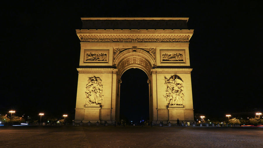 Triumphal arch against sky at night