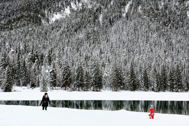 People on snow field during winter