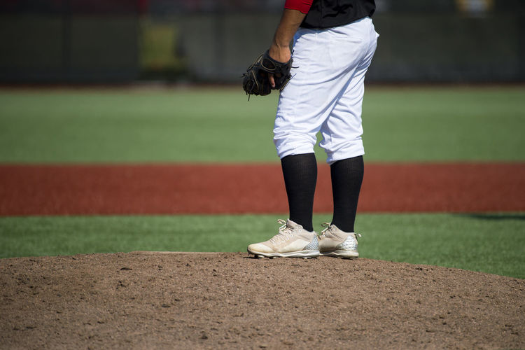 Low section of referee standing on playing field