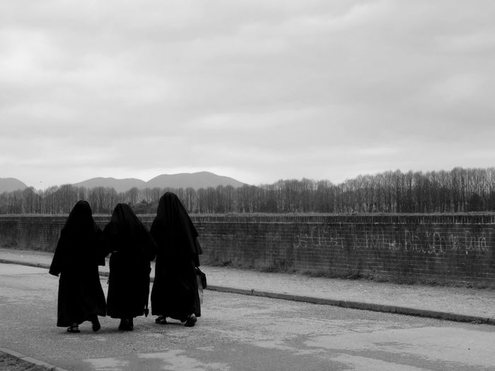 Rear view of women in burka walking on street