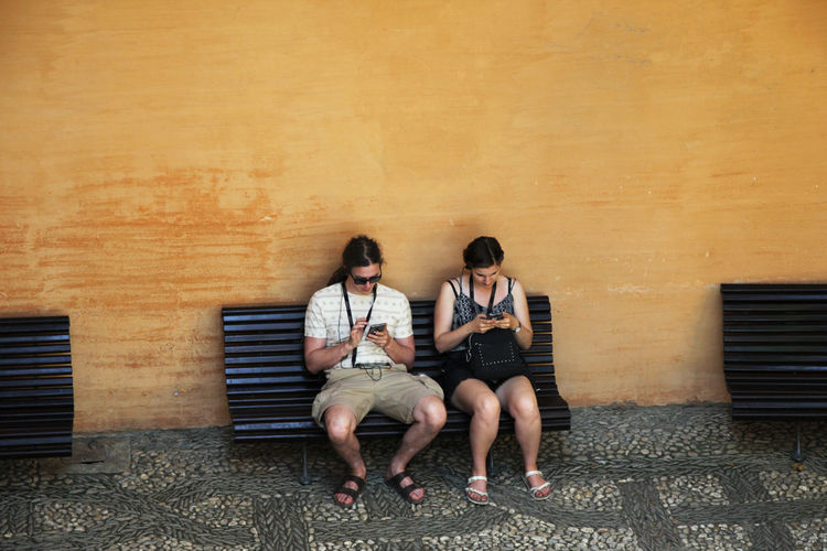 Young couple sitting outdoors