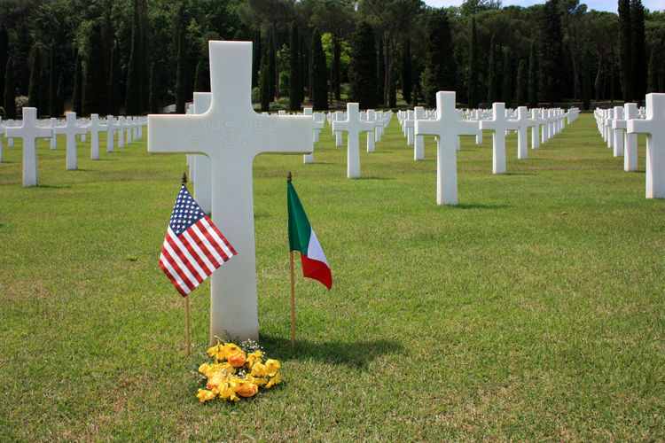 Crosses in green field memorial cemetery of american soldiers died in the second world war