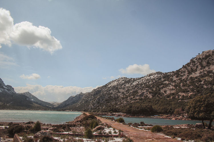 Scenic view of lake and mountains against sky