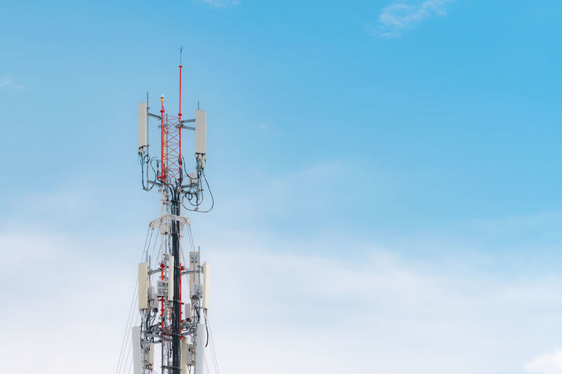 Telecommunication tower with blue sky and white clouds background. antenna on blue sky. radio.