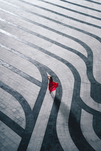 High angle view of woman standing on footpath