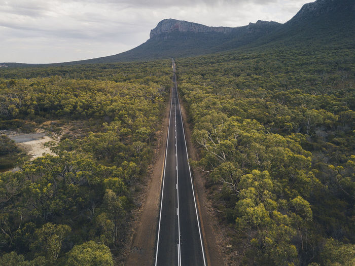 Aerial endless road towards mountains at the grampian national park, victoria, australia