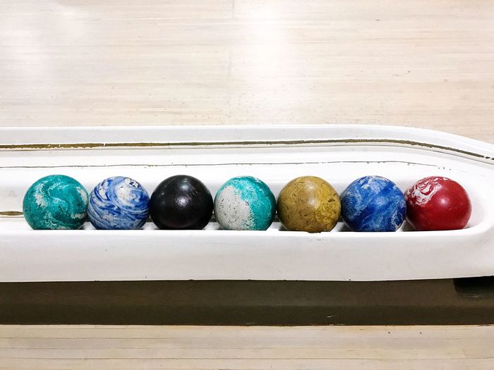 Close-up of multi colored easter eggs in bowling alley