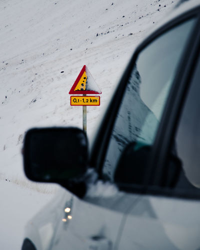 Warning falling rocks sign in eastern iceland. car window.