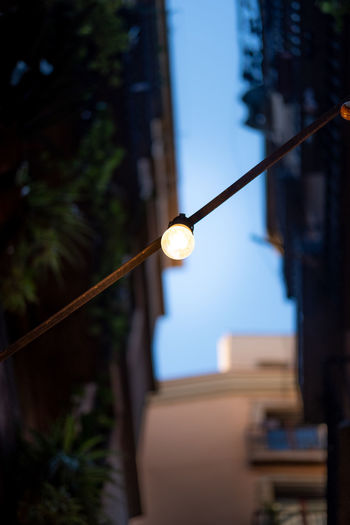 Directly below shot of illuminated light bulb against building