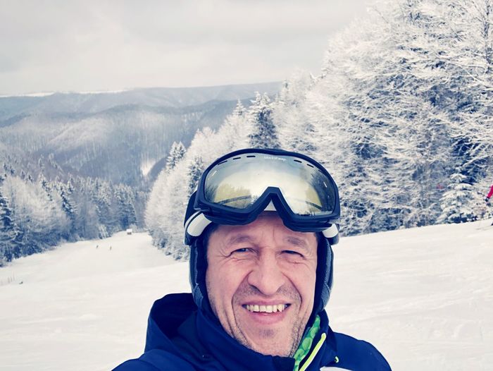 Portrait of smiling man on snow covered landscape