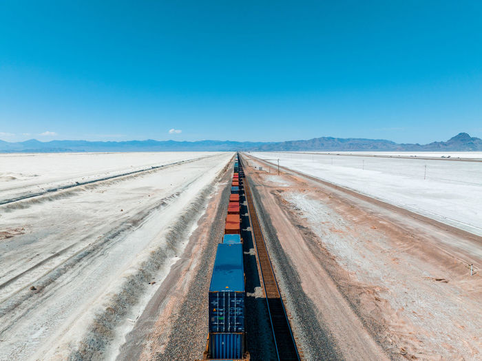Cargo train passing by the desert nevada, usa near salt flats.