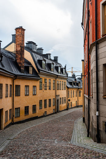 Street amidst buildings against sky. stockholm