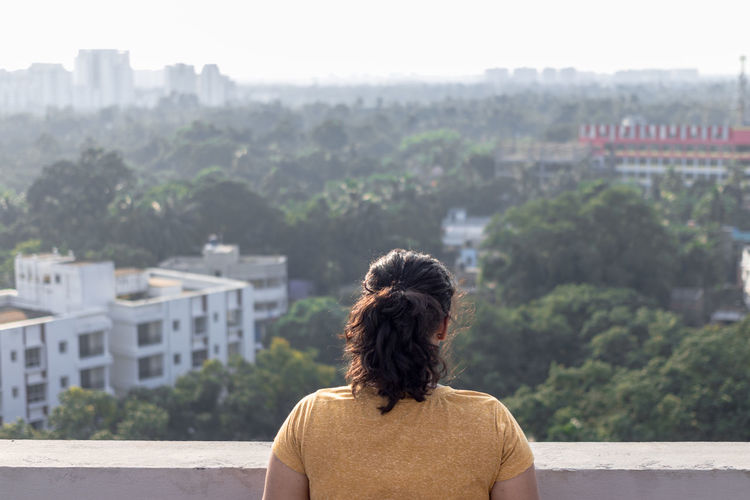 Rear view of woman looking at foliage 