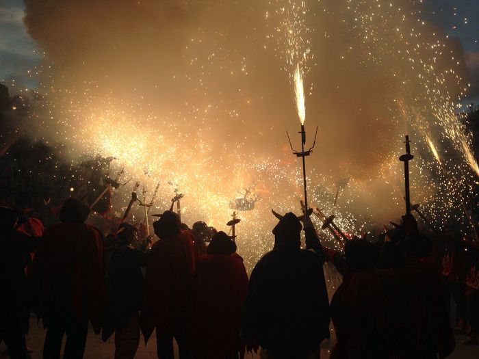 Silhouette people enjoying pagan festival at night