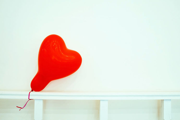 Close-up of red heart shape against white background