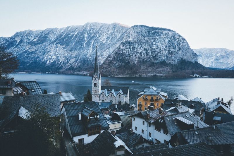 Buildings by lake at hallstatt during winter
