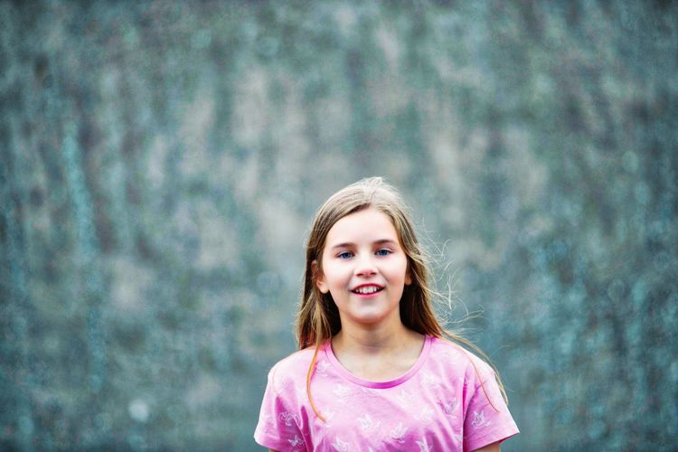 Portrait of happy girl standing in park