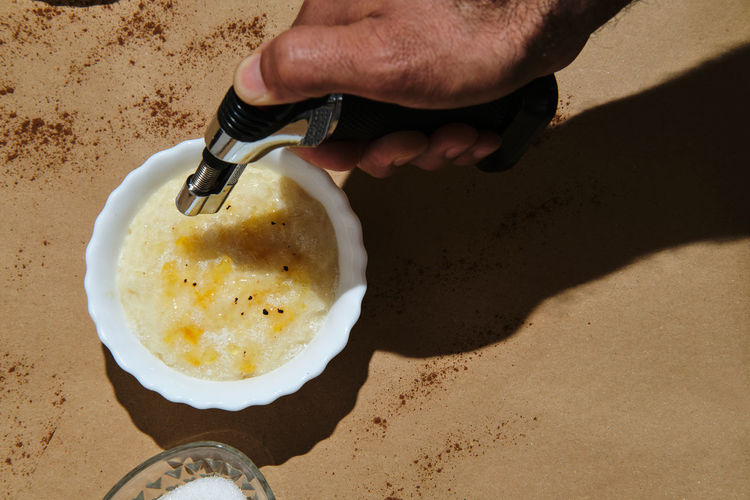 High angle view of person preparing food on sand