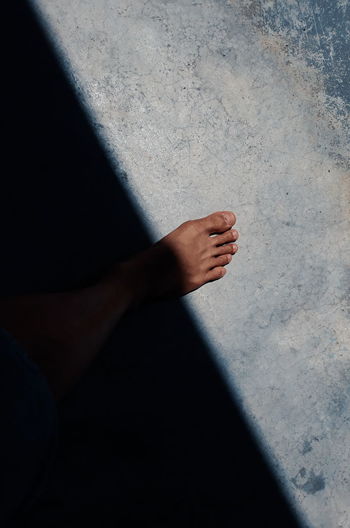 Close-up of human leg on flooring