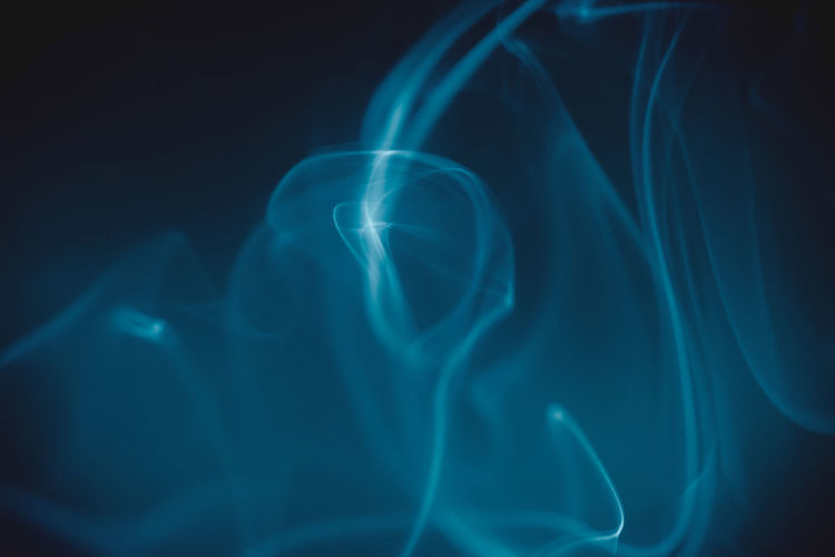Blue smoke swirling against a dark background.