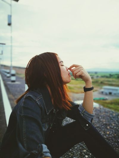 Close-up of young woman holding nose 