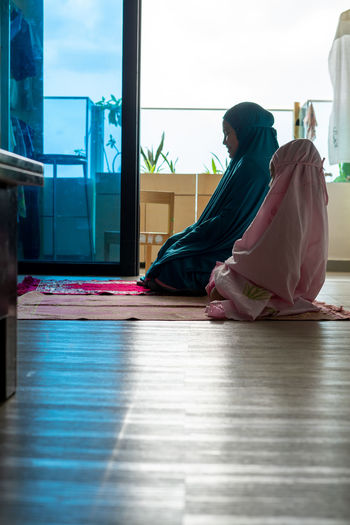 Muslim children praying at home. learning to pray for the little girl. happy and jovial child.