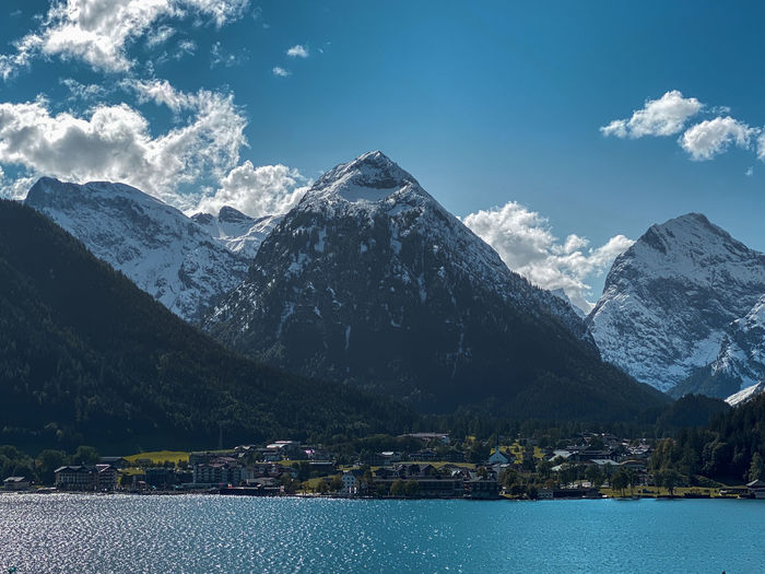 Scenic view of lake achensee, tyrol, austria and snowcapped mountains against sky