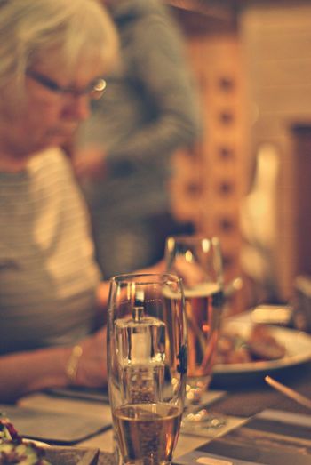 Close-up of woman at table with beer glass