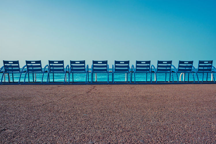 Famous blue chairs on beach of nice, france
