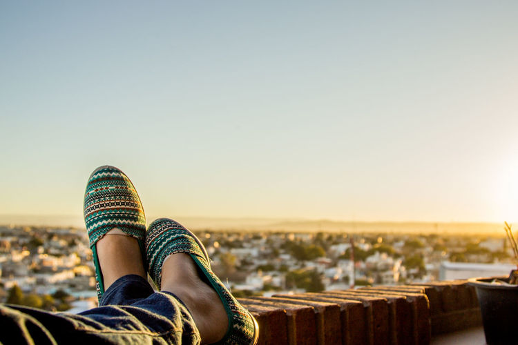 Low section of woman relaxing during sunset