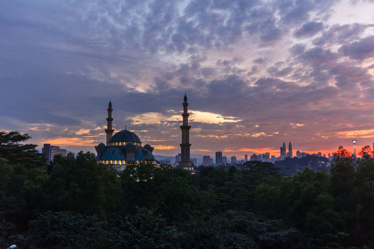 Panoramic view of buildings in city against sky during sunset