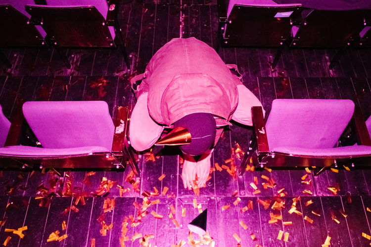 High angle view of man collecting confetti on floor