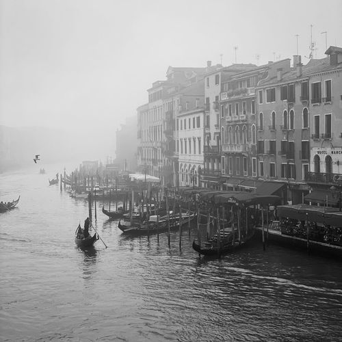 View of boats in canal against buildings