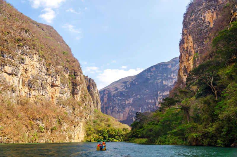 Boat in river at sumidero canyon against sky