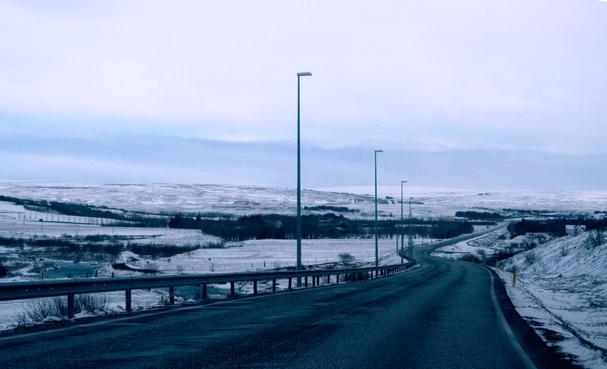Road passing through snow covered landscape