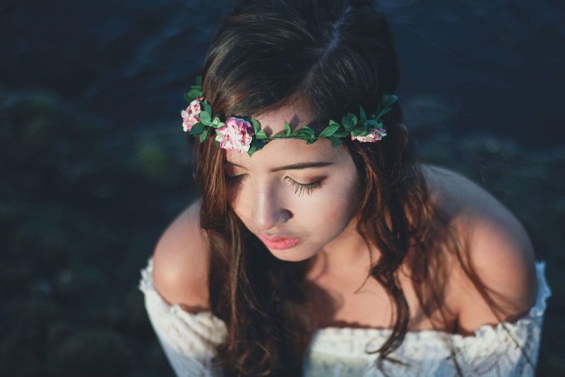 Close-up of beautiful woman with flowers in hair