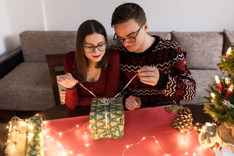 Young couple in love with christmas presents in a festive atmosphere