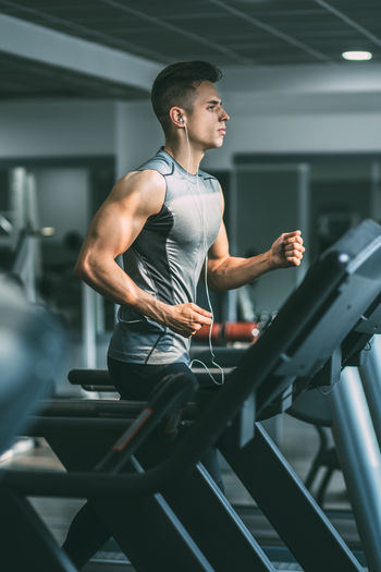 Man exercising on treadmill in gym