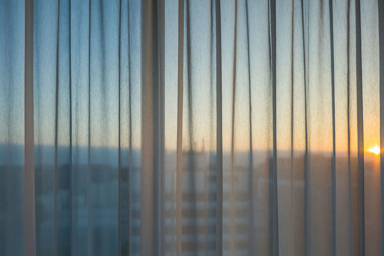 Sky seen through curtain during sunset