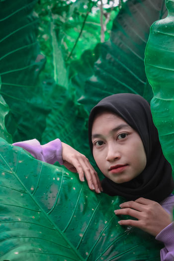 Portrait of a girl holding leaves