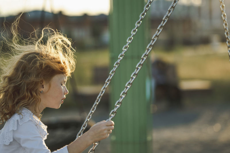 Girl swinging on swing at park