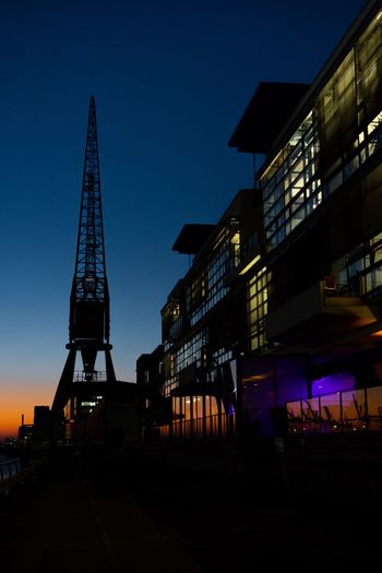 Illuminated building against sky at night