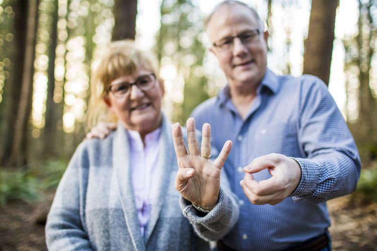 Older couple hold out 40 with fingers during 40th anniversary