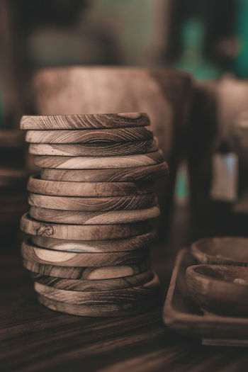 Stack of wooden plates on table