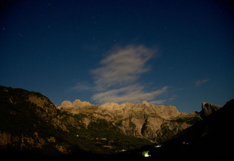 Low angle view of mountains against sky at night