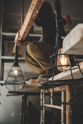 Man fixing light bulbs on ceiling