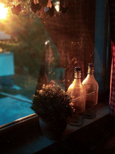 Close-up of illuminated glass bottle on table